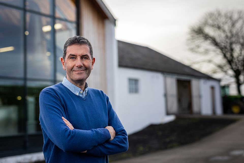 John Campbell posing outside Lochlea Distillery