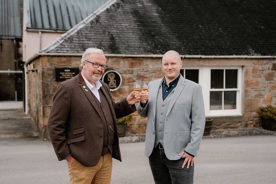 John MacDonald and David Rogerson toast outside Balblair Distillery